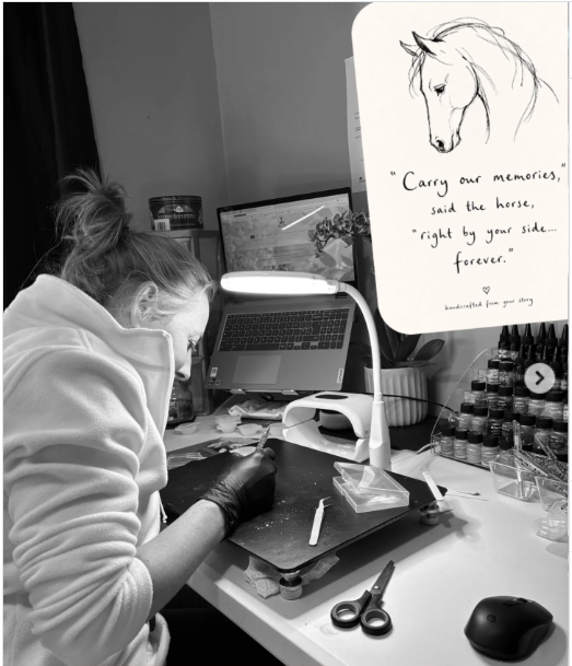 Person working at a desk, focused on a project with a horse drawing and inspiring quote.