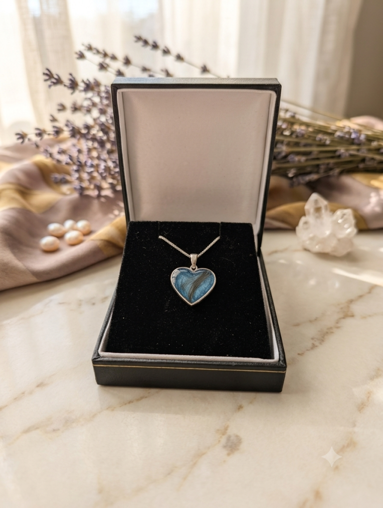 Solid silver heart pendant Silver heart-shaped pendant on a black velvet display inside a jewellery box.