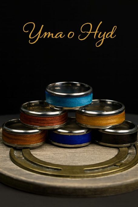 A stack of six decorative rings in various colours on a round wooden base.